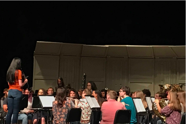On May 8, before the main section of the concert begins Miranda Versaw, 12, stands in front of the band to tune the instruments. 