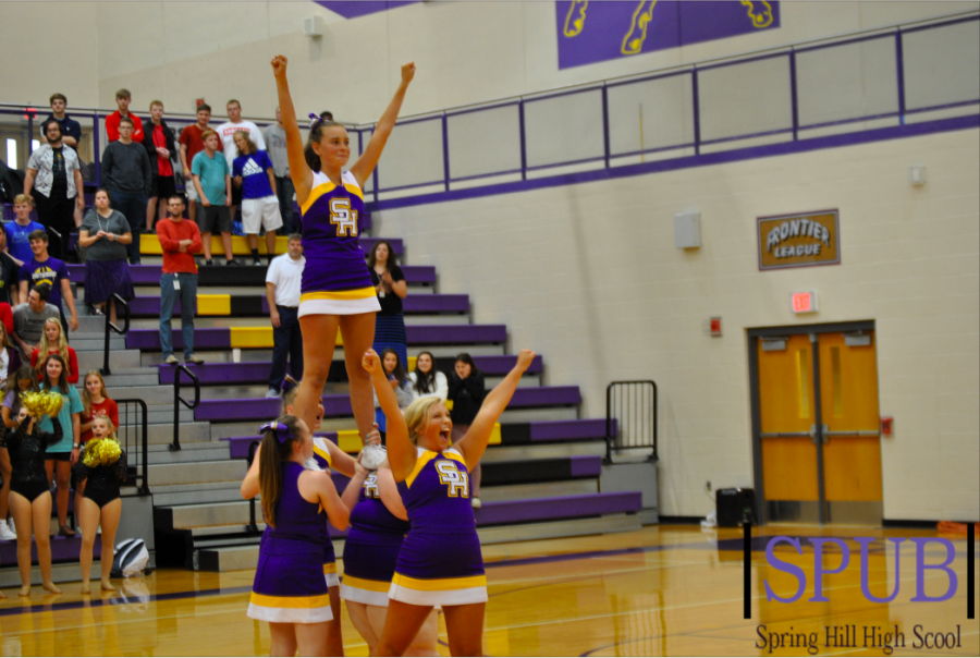 During their performance at the pep assembly, on Aug. 19, Gillian King, 9, is lifted by her fellow cheerleaders, Rachel Belcher, 11, and Emily Noll, 10. Alivia Bates, 10, stands in front of them and hypes of the crowd. (Photo by ZKnust)