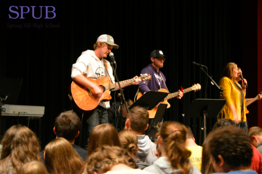 On Oct. 9, Noah Hunt, 12, helps lead students in worship at Fields of Faith. Usually out on the football felid this year, however, it had to be moved inside to the auditorium due to rain (Photo by K.Clooney).