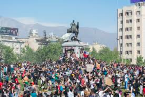 Chilean citizens protesting in the streets about the political unrest. The APEC and UN summits were canceled because of the massive amounts of protest.