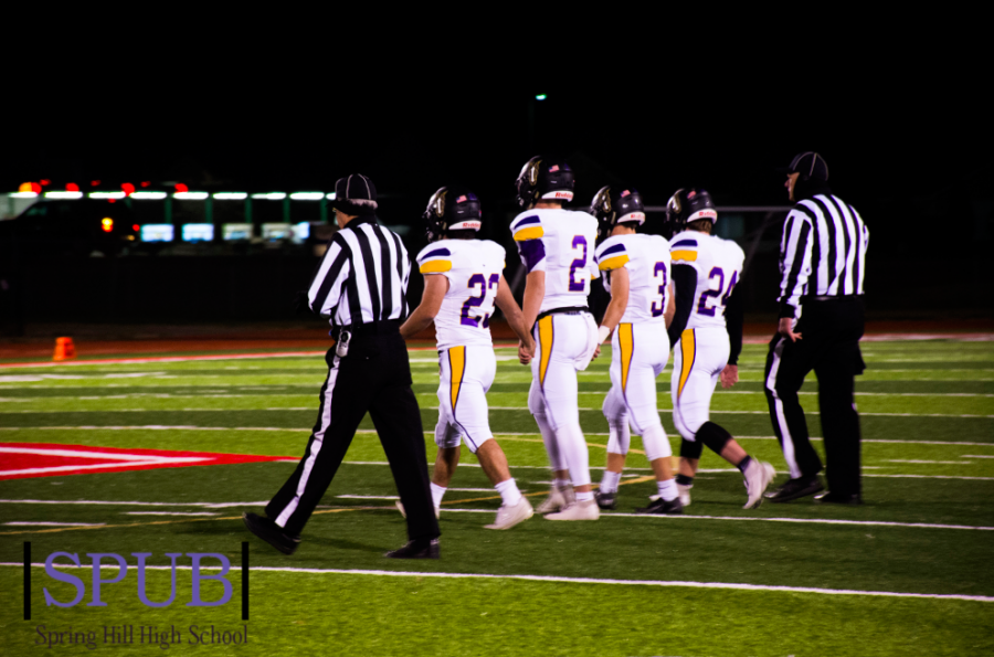 Team Captions, Zade Barker, 12, Corbyn Myers, 12, Hunter Wilyard, 12, and Jakob Stovall, 12 walk out for the coin flip. This would be the last coin flip of their senior year (Photo by AAnderson). 