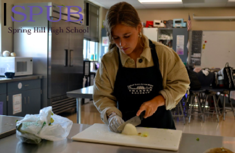 Ana Martinez-Gonzalez chops onions in her Culinary Arts class. “My favorite part was the food, and sitting with the family,” said Martinez-Gonzalez (Photo by LGonzalex-Diez).