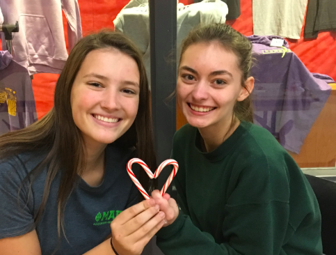 On December 9, StuCo members Meg Putnam, student body president,  12, and Jaden Gallagher, theater rep 12, sell candy canes. "[Winter wishes are a morale thing... it gets you in the holiday spirit," said Putnam (Photo submitted by TDent). 
