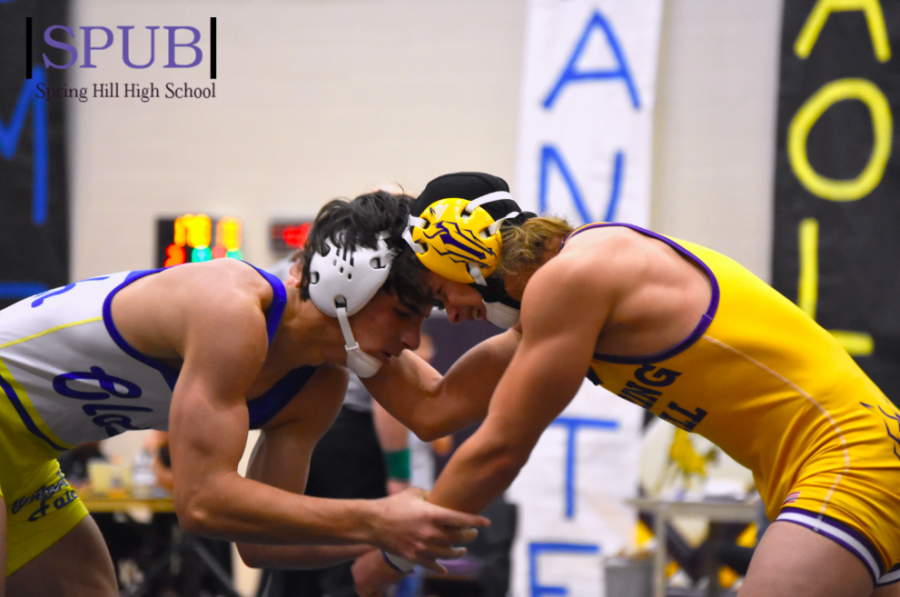 On Dec. 5, Josh Dickie, 12, battles against another wrestler during his first meet of the season. The first meet was Big Versus Littles were little schools are given the opportunity to wrestle against bigger schools (Photo by KOaks).  