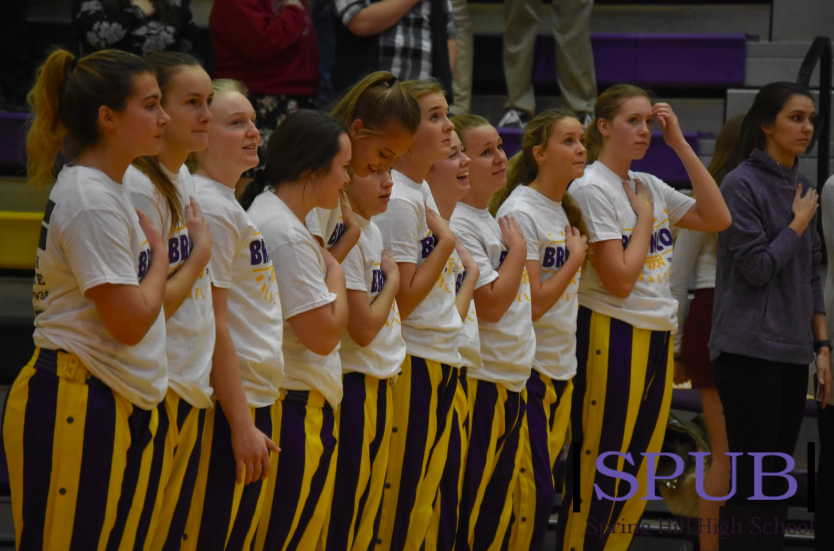 The varsity girls basketball team as they stand for the National Anthem. The girls went on to beat Atchison in their first game of the season (photo by A Frigon).