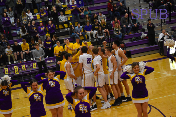 The cheerleaders lead the crowd in Fight Song before the varsity boys basketball game starts. The boys played on Dec. 13 and lost to Lansing High School (Photo by MSutton)