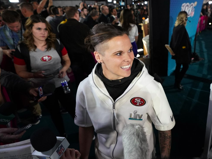 On Jan. 27, Katie Sowers, Assistant Coach for the 49ers, talks to reporters during the opening night for Superbowl 54. Sowers  is the first female and openly gay coach to work a Superbowl (Photo courtesy of AP Photo and David J. Phillip). 
