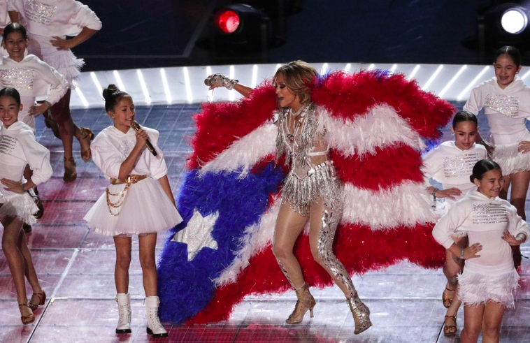 For+the+54th+Super+Bowl+Jennifer+Lopez+and+daughter+Emme+Maribel+Muniz+preform+together.+Lopez%E2%80%99s+daughter+sang+%E2%80%9CBorn+in+the+USA%2C%E2%80%99+while+her+along+with+other+children+emerged+from+what+seemed+to+be+cages+%28Photo+Courtesy+of+AP+Photo+and+Charlie+Riedel%29.+