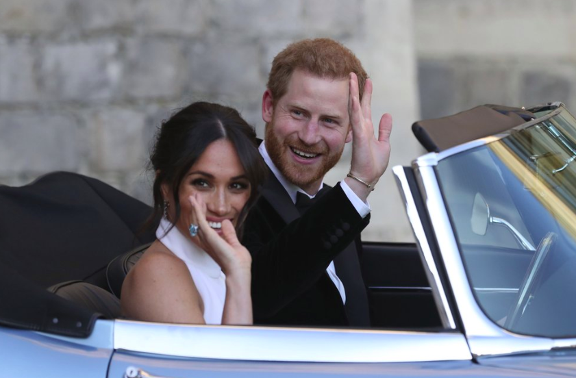 On May 19, 2019, the newly married and former Duke and Dutchess of Sussex, Prince Harry and Meghan in a convertible car after their wedding. They have since decided to leave the royal family (Photo courtesy by AP Photo). 