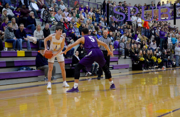 On February 7, Cooper Jones, 11, prepares to pass the ball during a varsity basketball game. The game took place on the night of Homecoming, and many people came to support it (PDenning). 