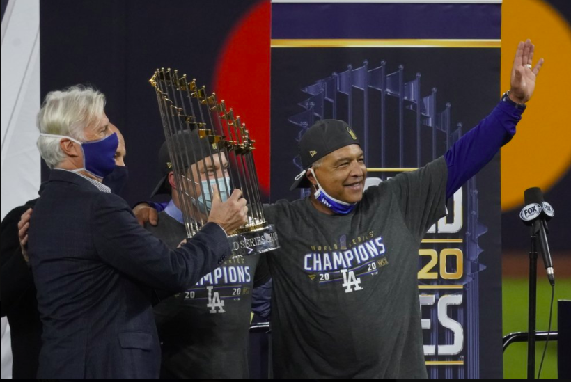 LA Dodgers manager Dave Roberts poses with the World Series trophy. He led the Dodgers to victory, ending the 30-year championship drought (photo courtesy AP News).