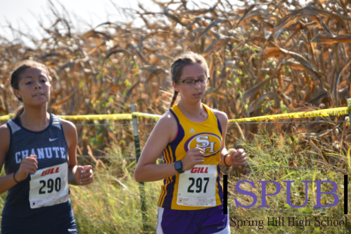 Hailey Hodge, 10, paces with another runner as she goes through her race (photo by R. White).
