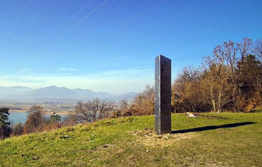 A picture of the monolith in Romania on Nov. 27. It has since disappeared, leaving many to question the odd appearances and sudden vanishings of this metal construction (photo courtesy AP News).