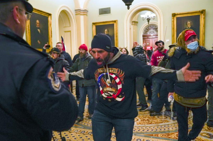 On Jan. 6, a man yells at a Capitol police officer stopping him from forcefully entering the Senate chamber. This man is one of hundreds that stormed the Capitol, hoping to disrupt the vote count that would certify President-elect Joe Bidens victory (photo courtesy AP News).