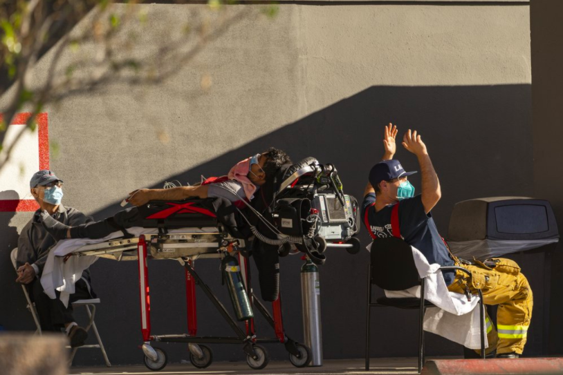 At this California hospital, there is no space to take on more patients, leading those who need care like this man to receive oxygen and other life-saving resources outside the building. While this is a large issue in L.A., cities across the country are facing this problem (photo courtesy AP News).