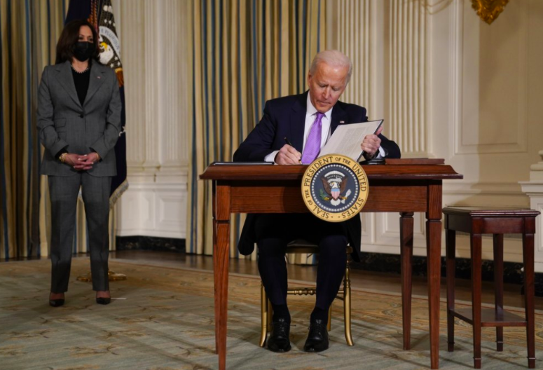 President+Joe+Biden+signs+executive+orders+in+the+state+dining+room+on+Jan.+26+as+Vice+President%2C+Kamala+Harris%2C+stands+to+his+left.+As+Biden+finishes+his+first+week+in+office+by+digging+deeper+into+several+issues+many+americans+care+about+%28Photo+courtesy+of+AP+photo+and+Evan+Vucci%29.+