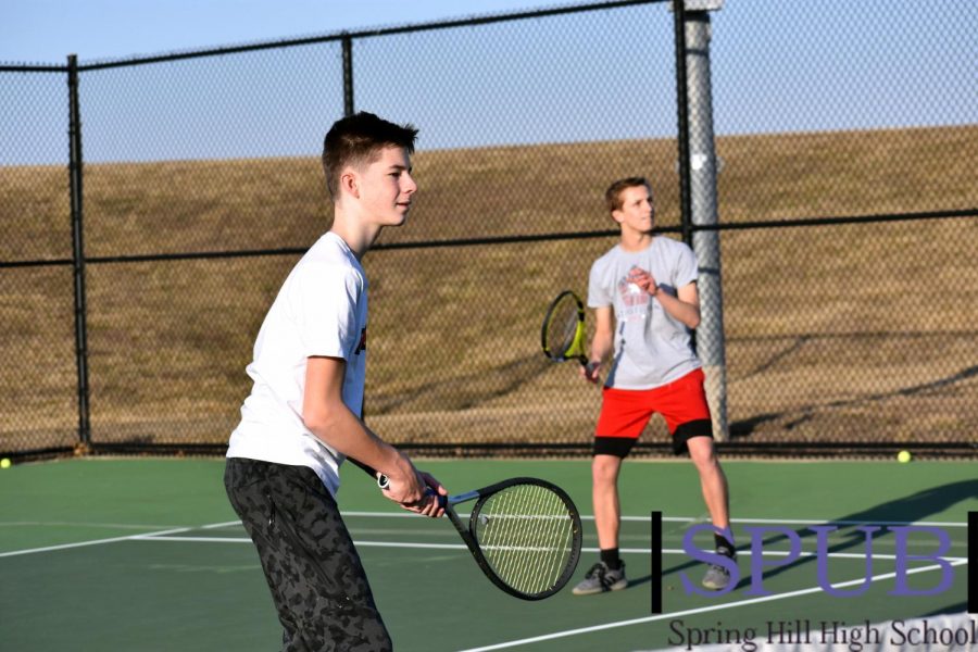 During practice, Joey Reinhart, 9, and Keagan Sinclair, 10, work on improving their volley skills while up at the service line (Photo by I. Williams).