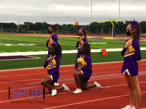 Lauren Gachanja, 9, and Sylvia Thaithi, 10, kneel during the national anthem before a football game. Different forms of protesting have become more prevalent in recent months, as the Black Lives Matter movement has gained nationwide attention; students at Spring Hill talked about how they felt about the movement (photo submitted by G. Roberts).