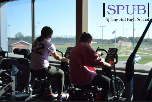 Delaney Hill, 10, and Emery Stevenson, 10, use the bikes in girls weights on a free day (photo by L. Haney).