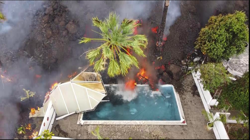 A swimming pool in Spain gets flooded with lava from the volcanic eruption (Photo Courtesy AP News). 