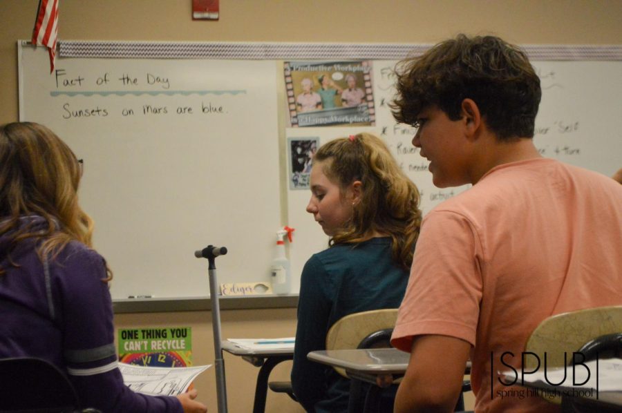 On Oct. 21, English students designed their own poster about the poem The Raven by Edgar Allan Poe. English students Ashton Hinds, 9, and Cooper Olson, 9, discuss the project in Kelly Edigers English class.
