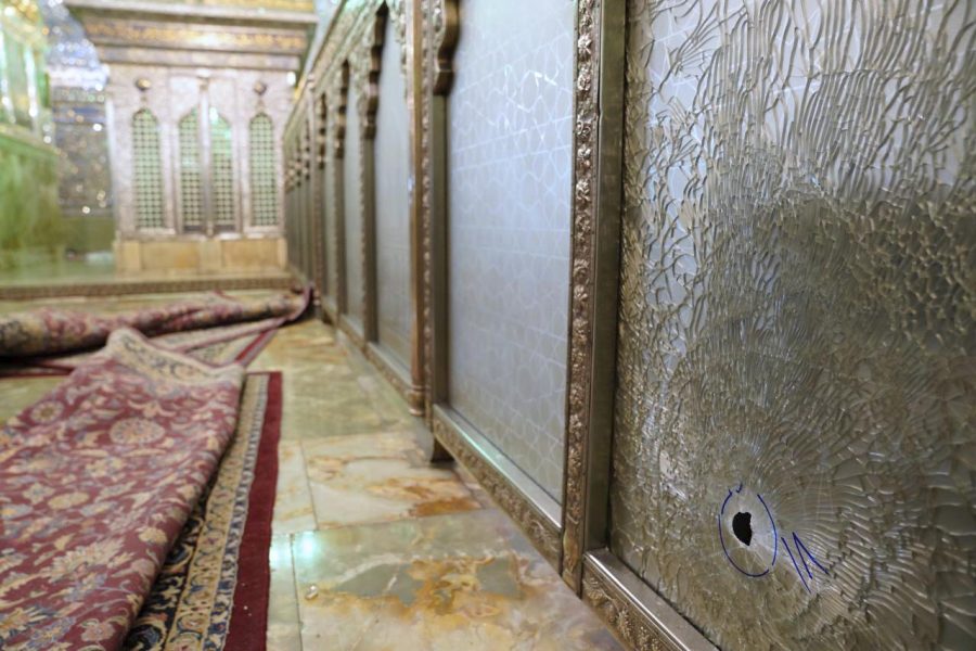 A bullet hole can be seen in the glass window of the Shah Cheragh shrine (photo courtesy AP News).