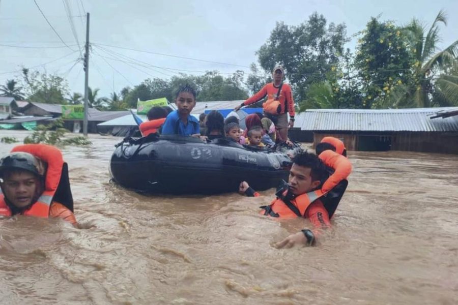 Rescuers use boats to help transport people out of flooded regions (photo courtesy of AP News).
