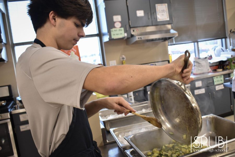 On Jan. 31, Calen George, 10 combines his finished dish with the others that his classmates cooked.