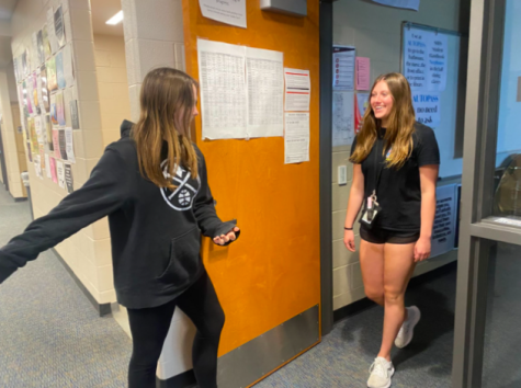 Shelby Hatcher, 10, opens door for Brynna Pierson, 10. (Photo by A. Rushing)