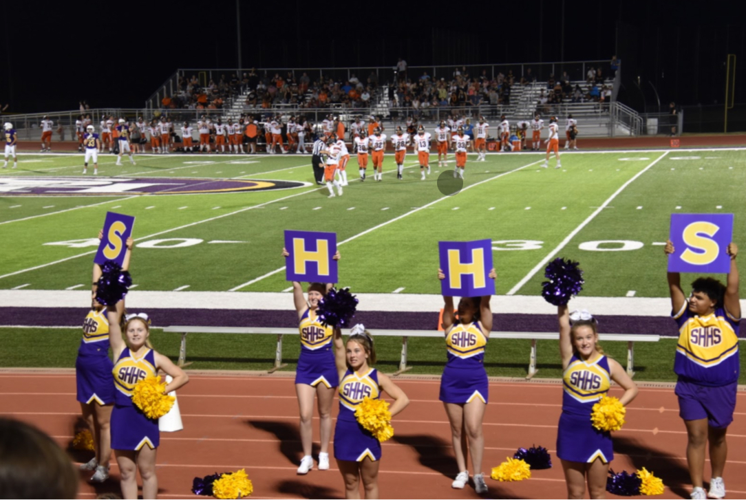   On Sept 1, the high school cheer team does a sideline cheer to hype up the student section. This game was against the Bonner Spring Braves. (Photo by J. Amaro).