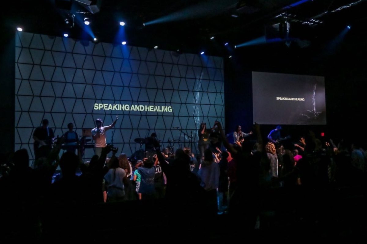 Many SHHS students attend Switch at Life Church. This picture shows students lifting their hands up while singing (Photo courtesy of Life Church).