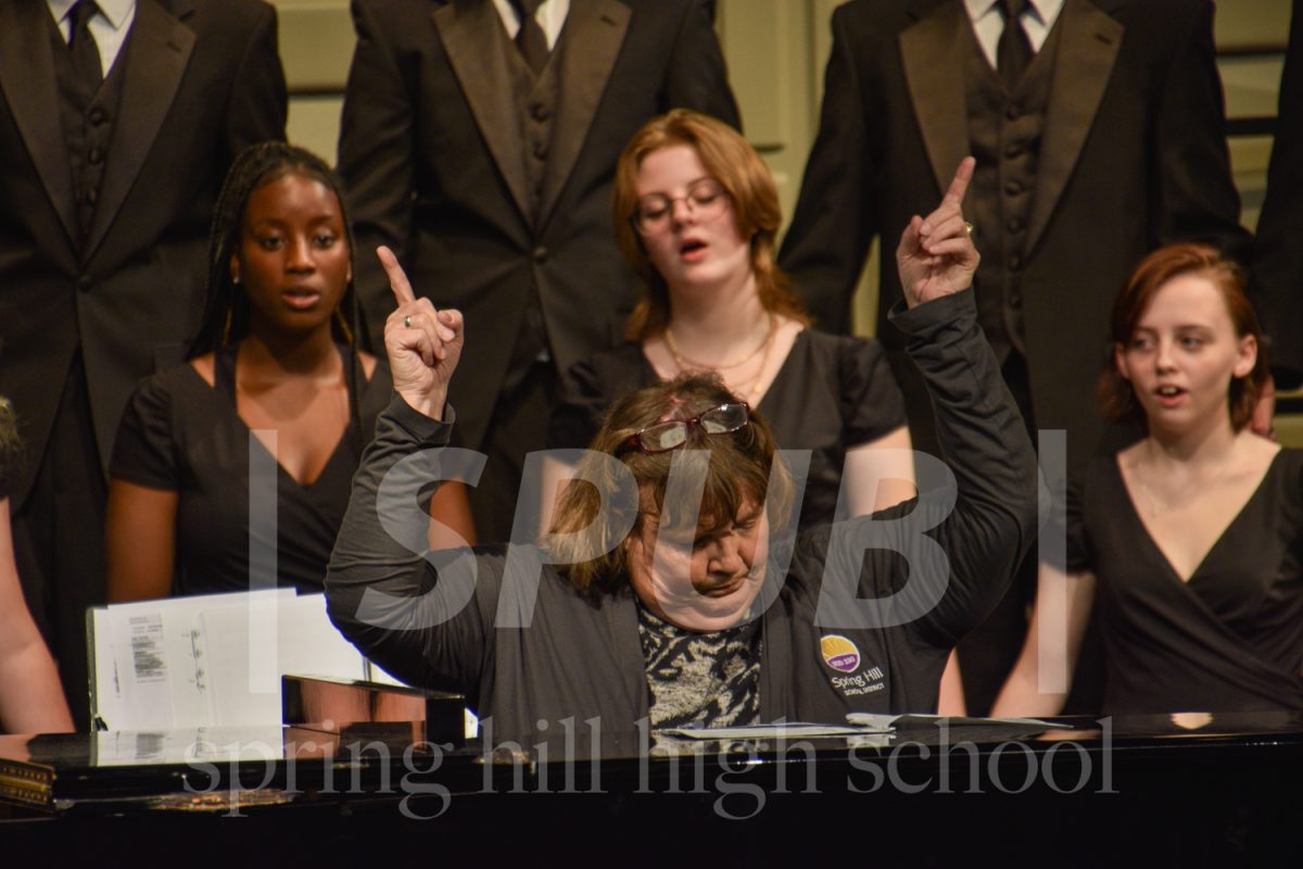Georann Whitman passionately conducts the choir at the Oct. 10 choir concert (Photo by: MMarmon)