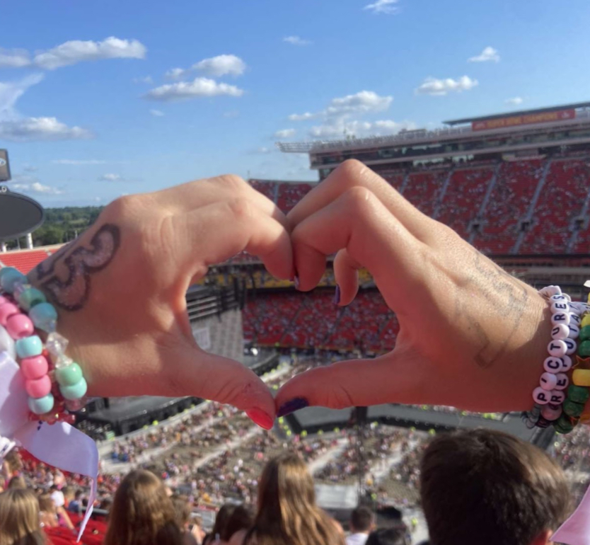 Madison Brown, 10, and Rylee Jones, 10 make heart hands while at “The Eras Tour” in Kansas City on July 8th. All Swifties should get the opportunity to experience the tour (Photo by M. Brown). 