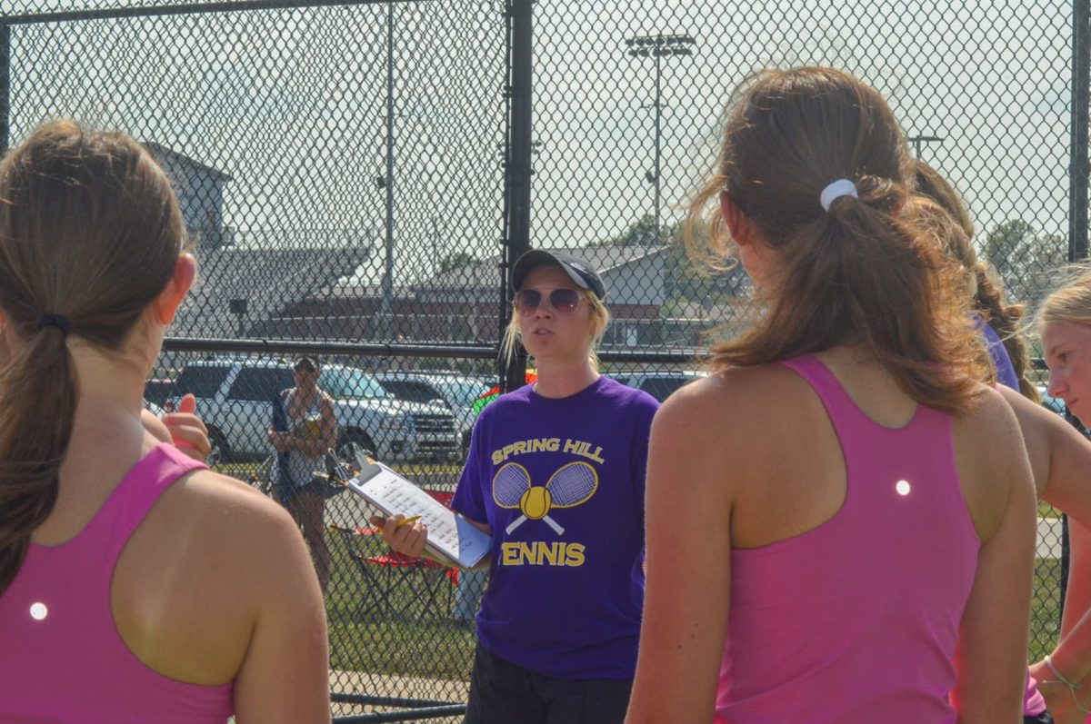 During the C-Team season opener, Paige Delgado, Assistant Tennis Coach begins the day by announcing matches. All players are gathered together one last time before all going out to start their beginning matches (Photo by A. Albright)