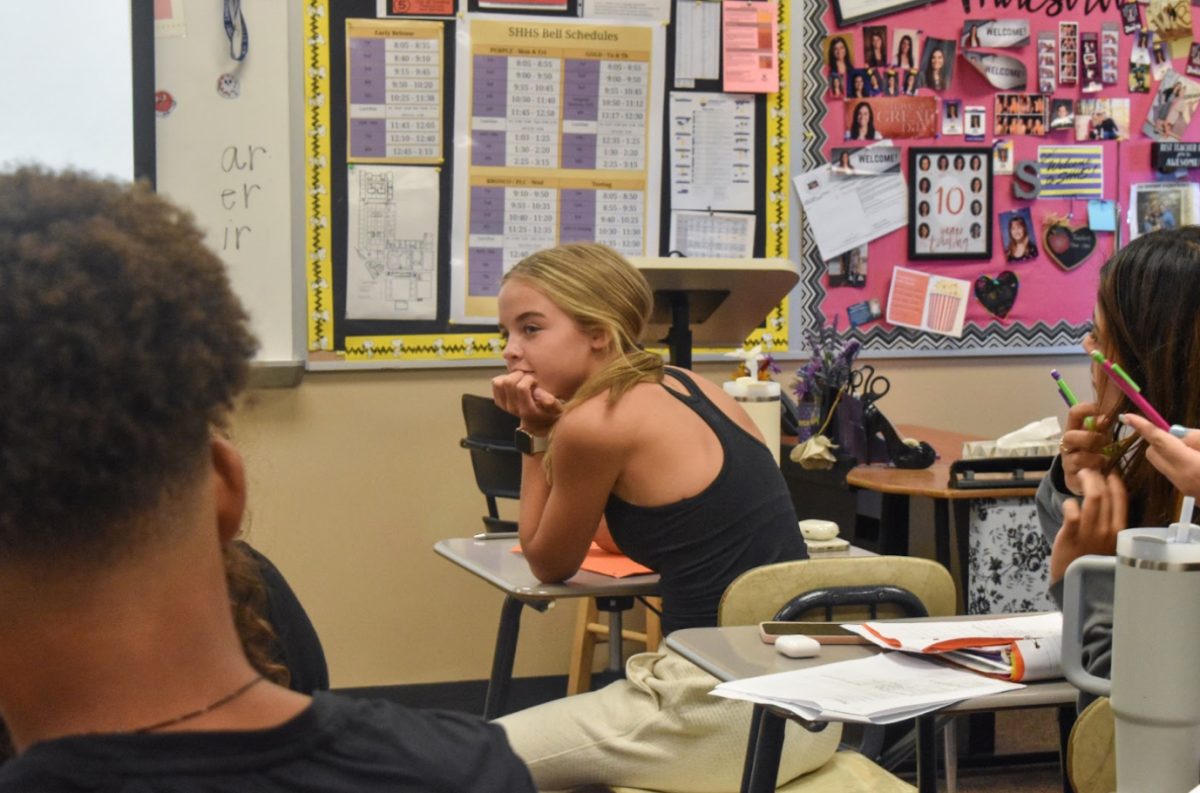 Emory Huntington, 9, listens to a peers question during Spanish I. They are taking notes, being interactive with her peers and focused on the lecture (Photo by A. Albright). 
