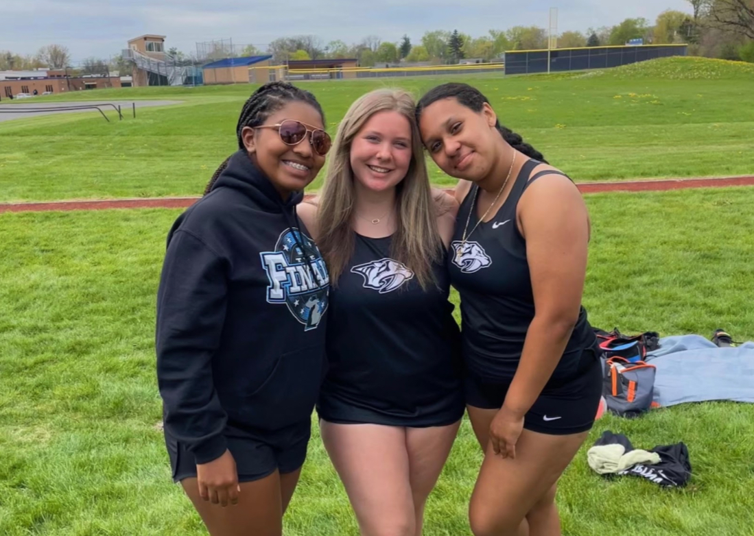 Ashlyn Watson, 12, stands in the middle with their track friends at their old school in Plymouth, Michigan. The three competed at Regionals together for a spot at States (Photo by A. Watson).
