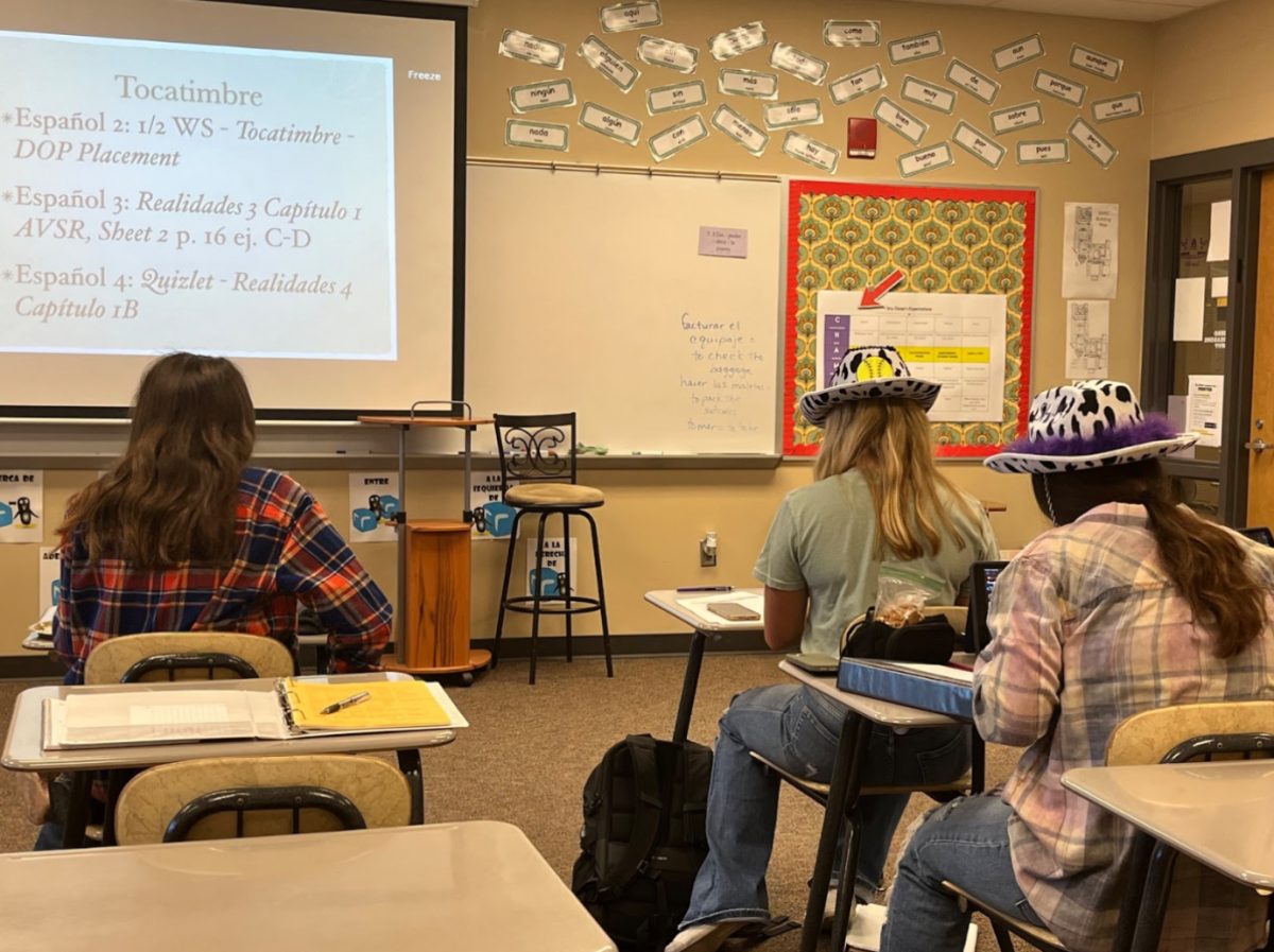 Spanish 4 students work on their bellwork before class is fully underway. Spanish is the only language class offered at the high school. (Photo by K. Tran)