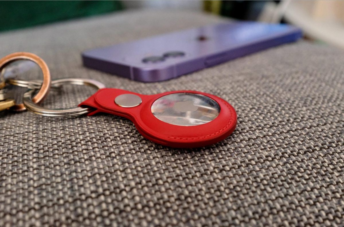 An Apple Airtag attached to a keychain. While their intended function is to help the user keep track of their things, Airtags can be used in far more criminal ways.