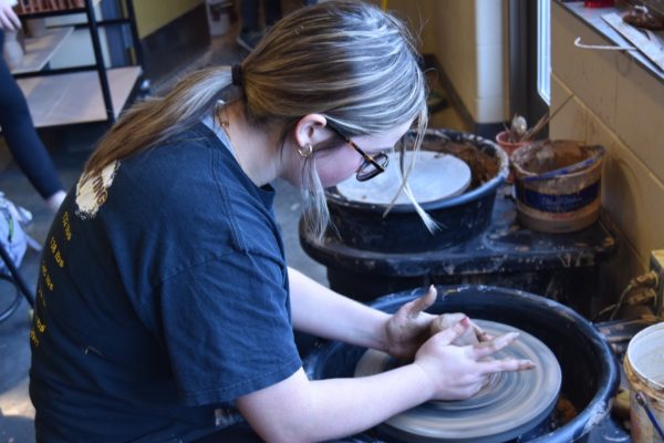 Ava Crabtree, 11, during their ceramics 3 class centering the clay. This is the most important step because if it is not centered, it may become uneven (Photo by A. Horne).