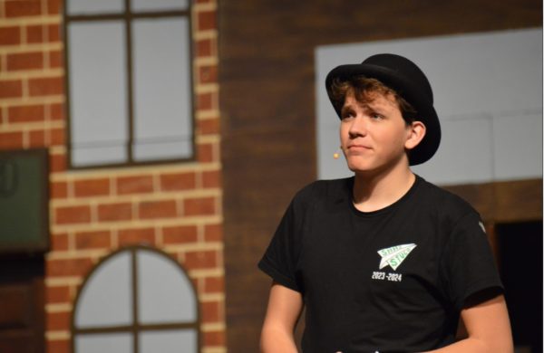 Ethan Knust, 12, rehearses in the auditorium for “The Music Man”. All of the practice and effort put into the acting ended in a success (Photo by B. Horne). 