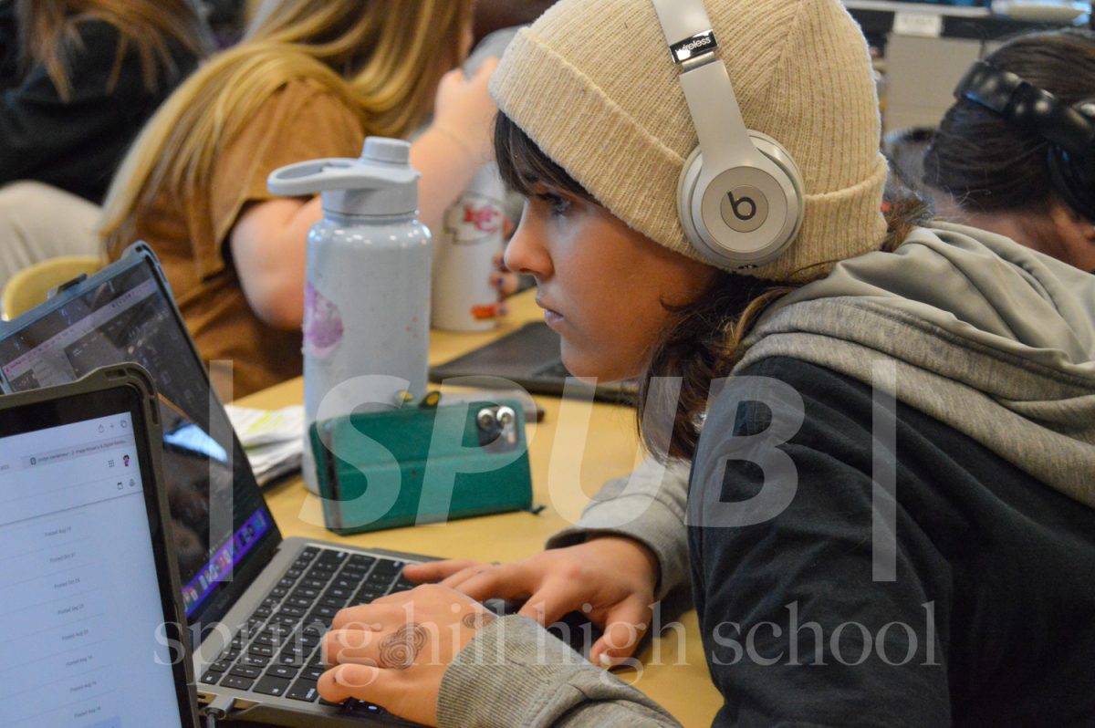 During photo imaging, Lenore Pinkerton, 9, works on their final exam project. During the last week of the semester, all photo imaging students reviewed skills learned previously in the semester. 