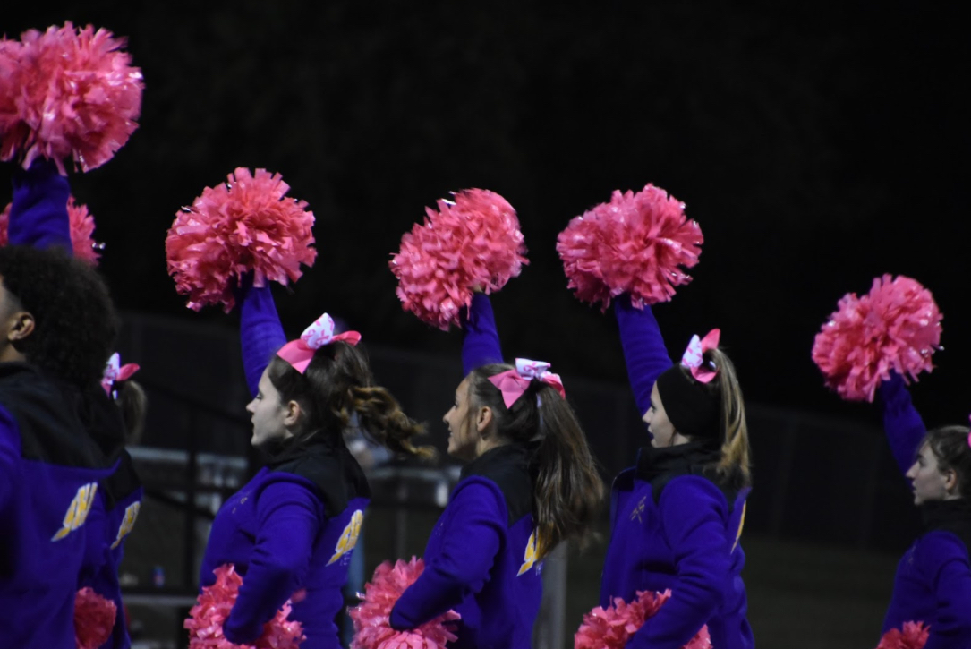 The+cheerleading+team+cheers+on+the+football+players+as+they+aim+to+score+a+touchdown.+Football+games%2C+along+with+other+sports%2C+help+the+team+prepare+for+upcoming+showcases+%28Photo+by+G.+Galloway%29.+