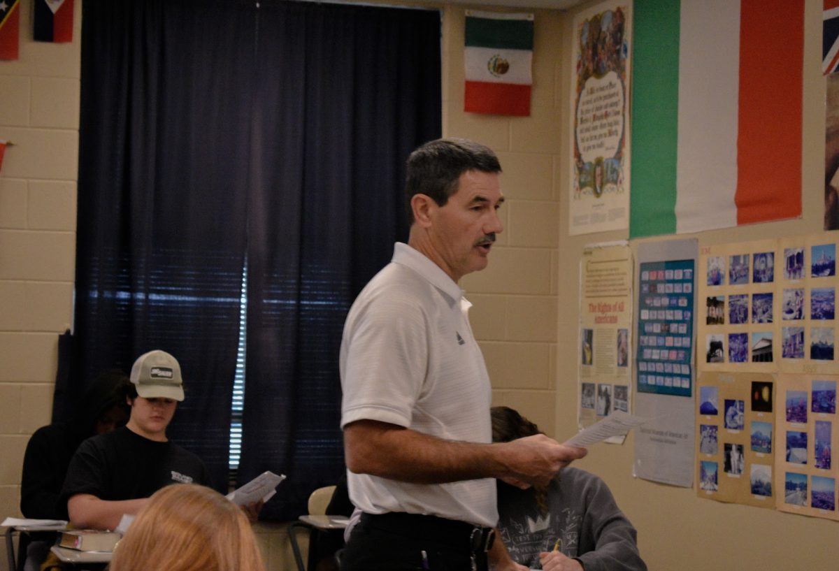 Paul Young, history teacher, reviews for the final test during American history. Wednesdays are pollo days which allows Young to take a break from the ties while still remaining professional (Photo by S. Hatcher). 