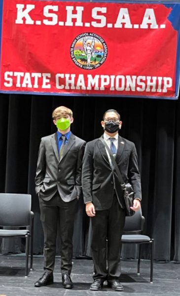 Torrez and Garcia pose in front of the state championship banner in the 2022 state championship. This was the first year that Garcia and Torrez were debate partners (Photo provided by L. Torrez). 