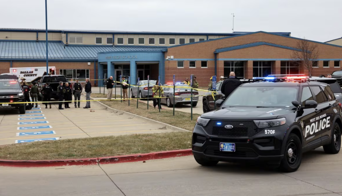  Law enforcement officers work at the scene of a shooting at Perry High School in Perry, Iowa, on Thursday. Minutes after closing down the scene officers were able to identify the shooter. (Scott Morgan/Reuters)