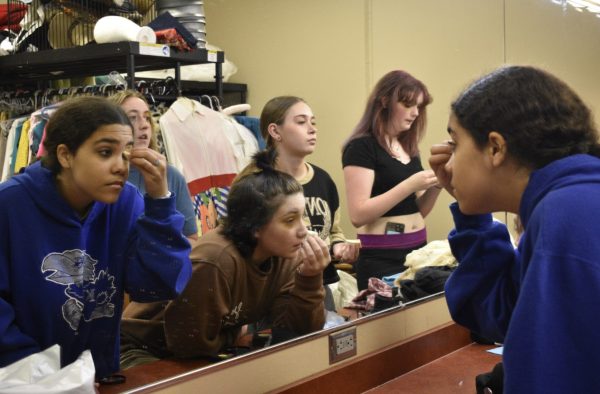 In freshman theater classes students learn how to apply fake scars and bruises. This technique incorporated stage makeup into theater education. (Photo by S. Hatcher).