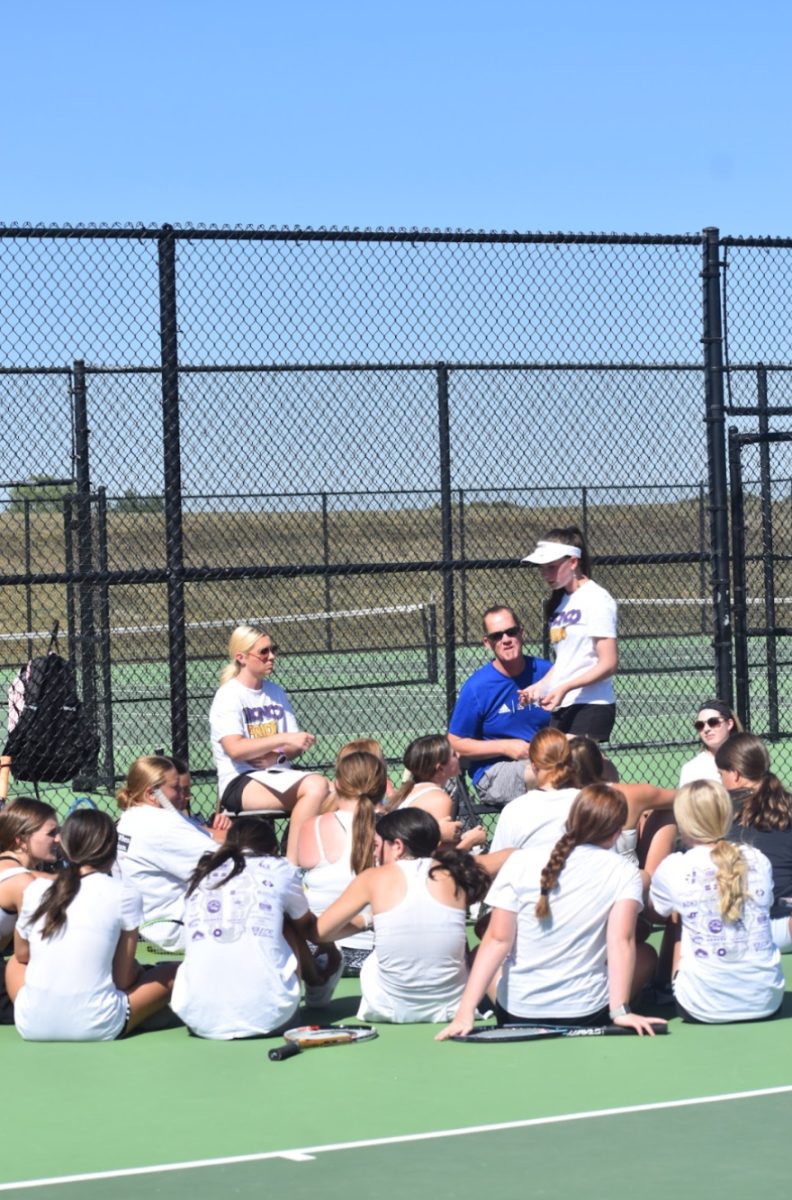 Delgado talks with the girl’s tennis team courts with Sherron. They share their thoughts and advice to the team (Photo by M. Ceniceros). 