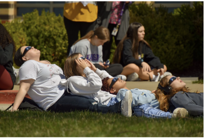 Students gather outside to watch the eclipse. Teachers took their students outside near the peak time. (Photo by D. Estes)
