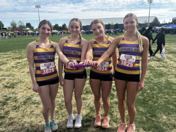 Adelyn Baur, 11, Ava Best, 10, Haylee Whitcraft, 12, and Kaylee Shupert, 10,  pose with a baton at KU Relays (Photo Provided by SHHS Track Instagram). 