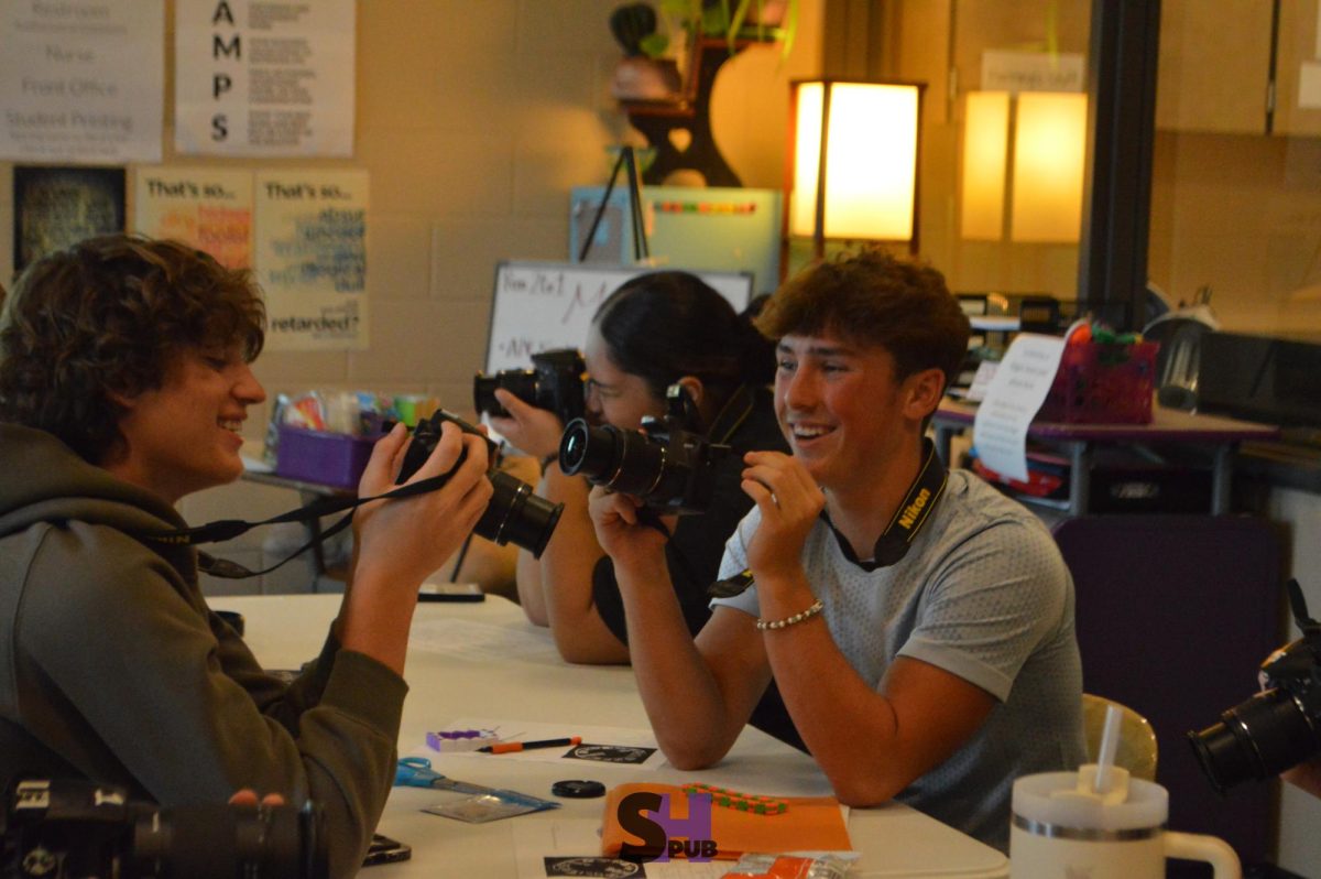 Treyson Schuckman and Keegan Fulk, 10, learn the basics of photography in Anna Manning’s photo imaging I class Sept. 12.